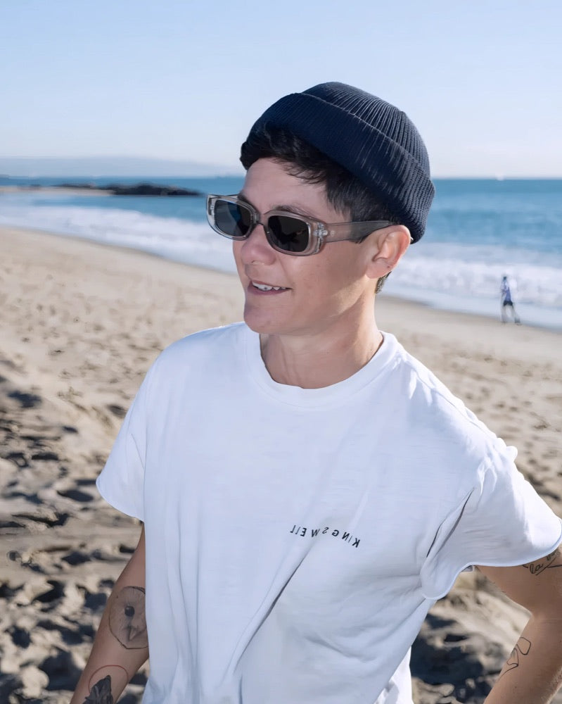 Man on the beach in grey CHPO sunglasses