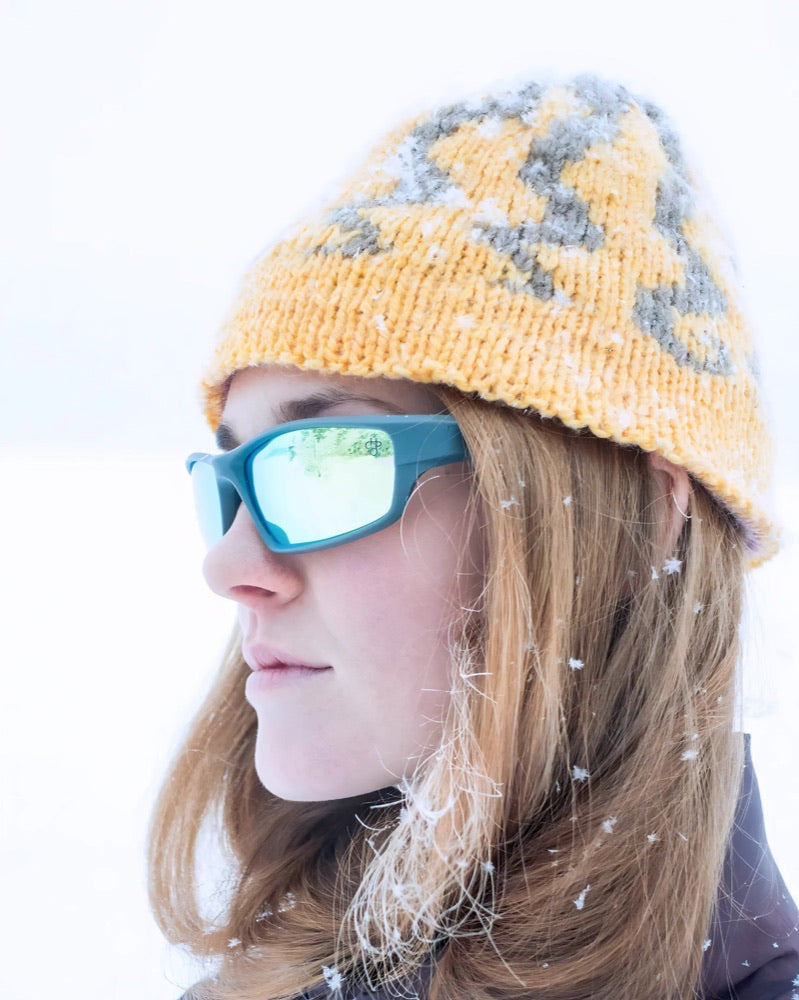 Woman in the snow with mirrored CHPO glasses
